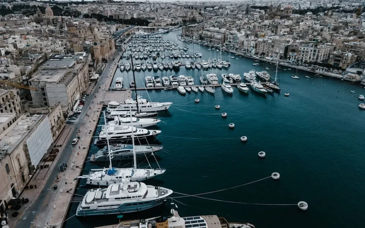 Aerial view of a marina in Malta with boats at their berths